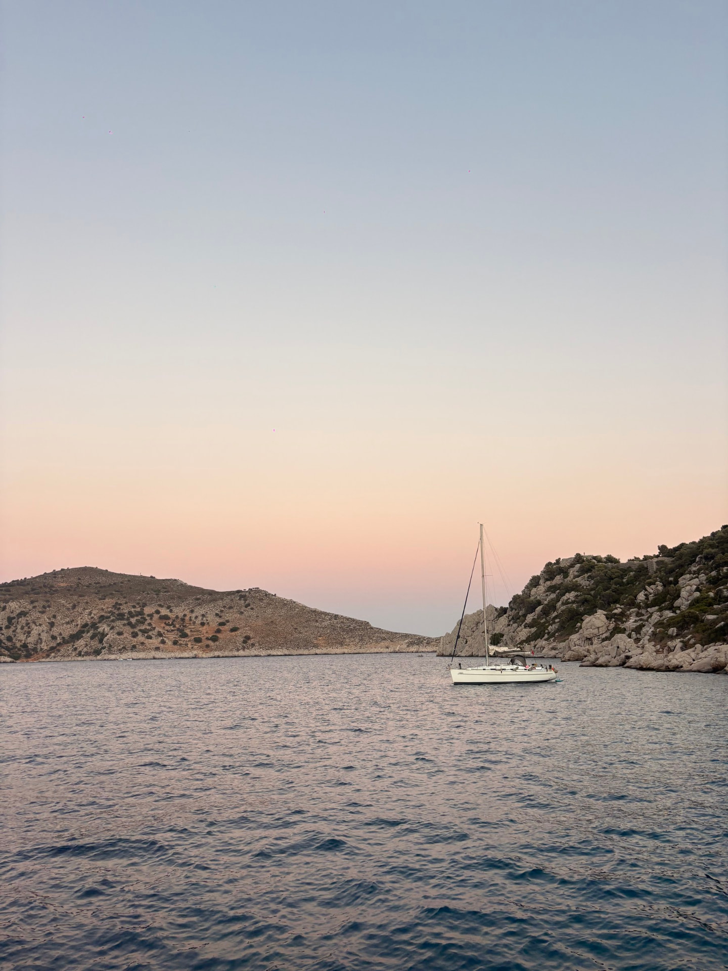 A sailboat on the water at sunset
