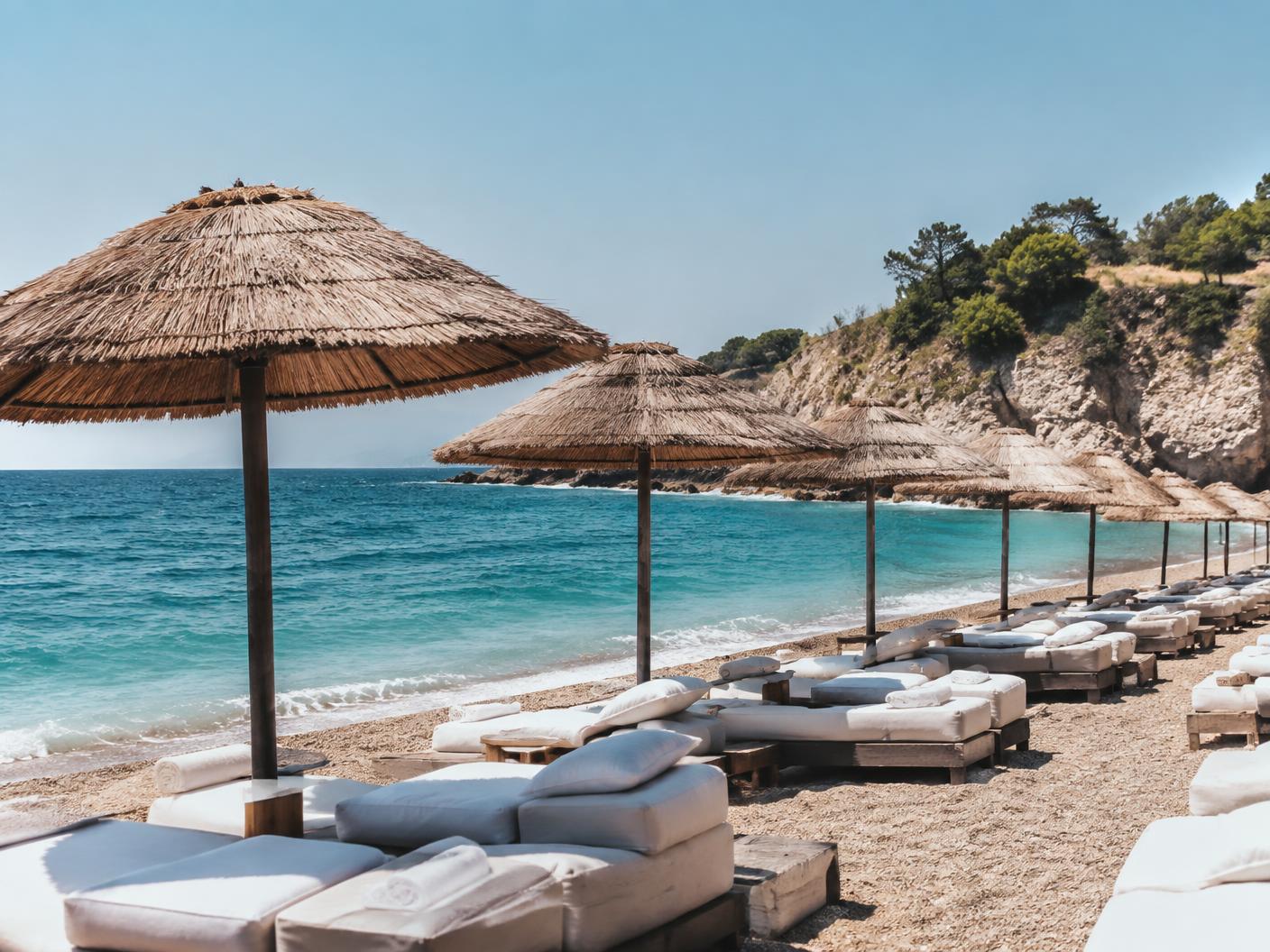 A Mediterranean beach club beside clear water
